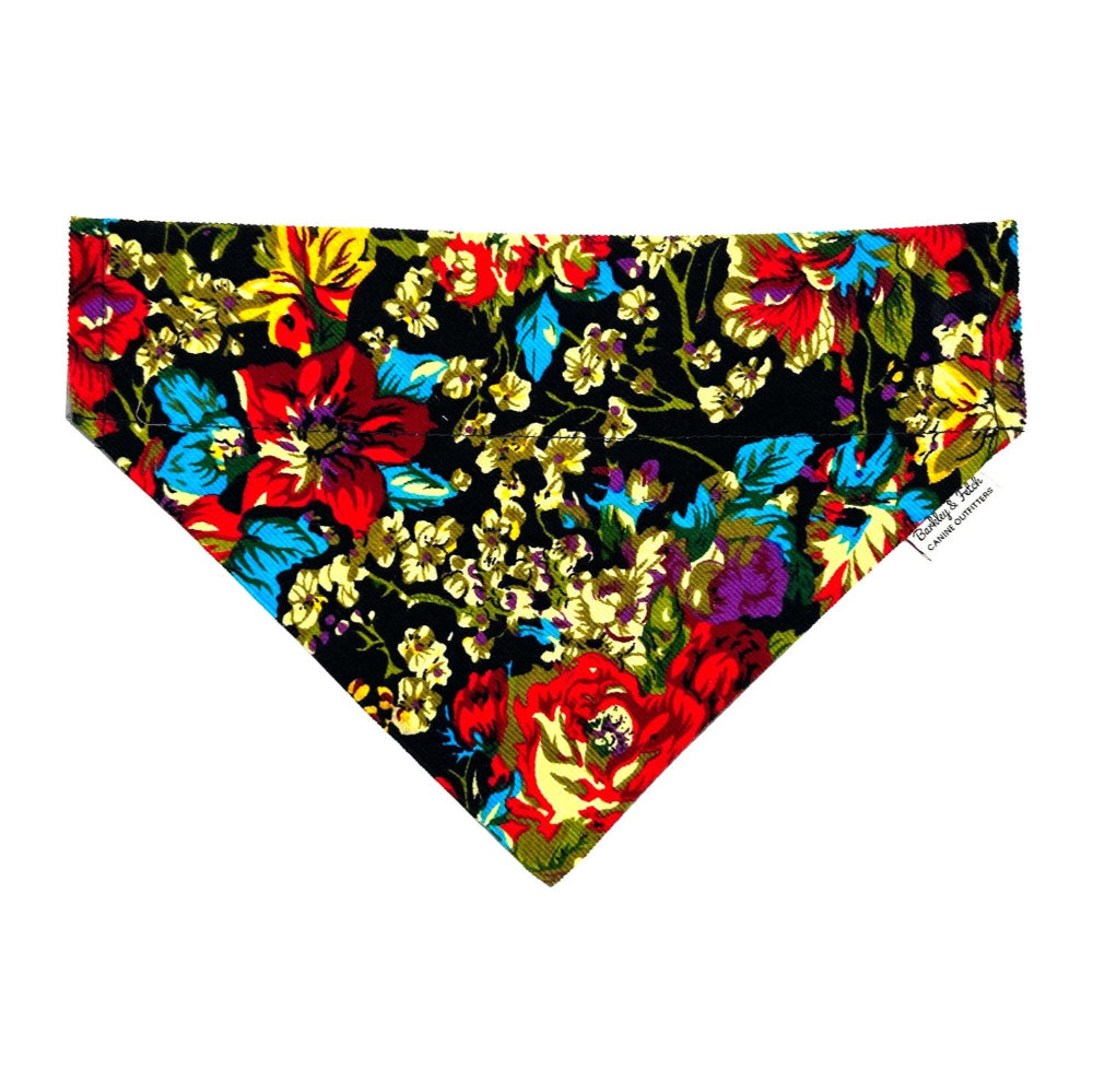 A multicolored floral corduroy fabric dog bandana with a prominent rose flower design.