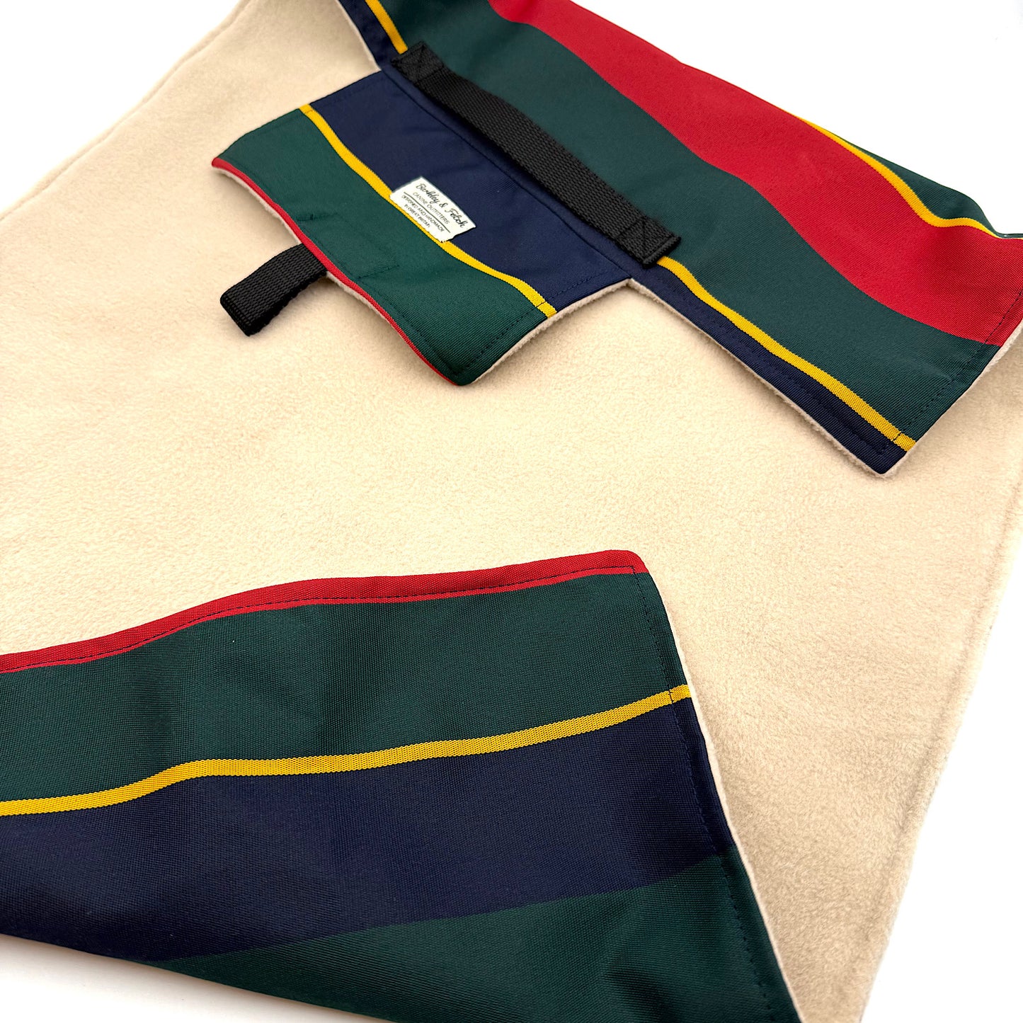 Colorful striped fabric settle mat with red, green, and blue pattern on a beige background handmade in UK by Barkley And Fetch