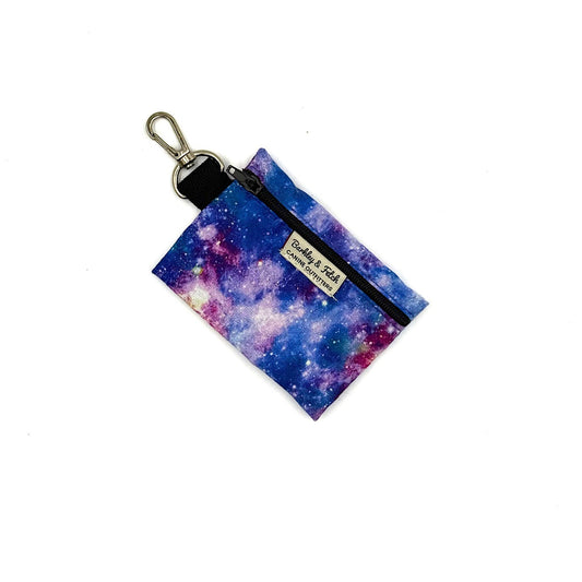 Keychain pouch with galaxy design and visible brand label on a white background