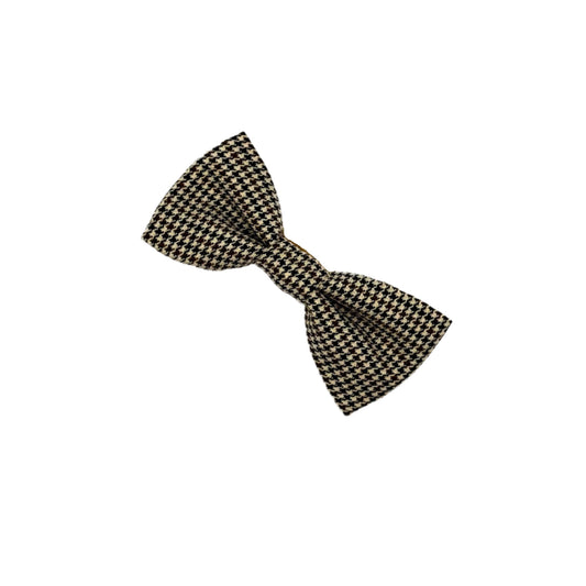 Black and gold checkered bow tie on a white background