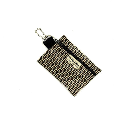 Houndstooth patterned pouch with keychain on a white background