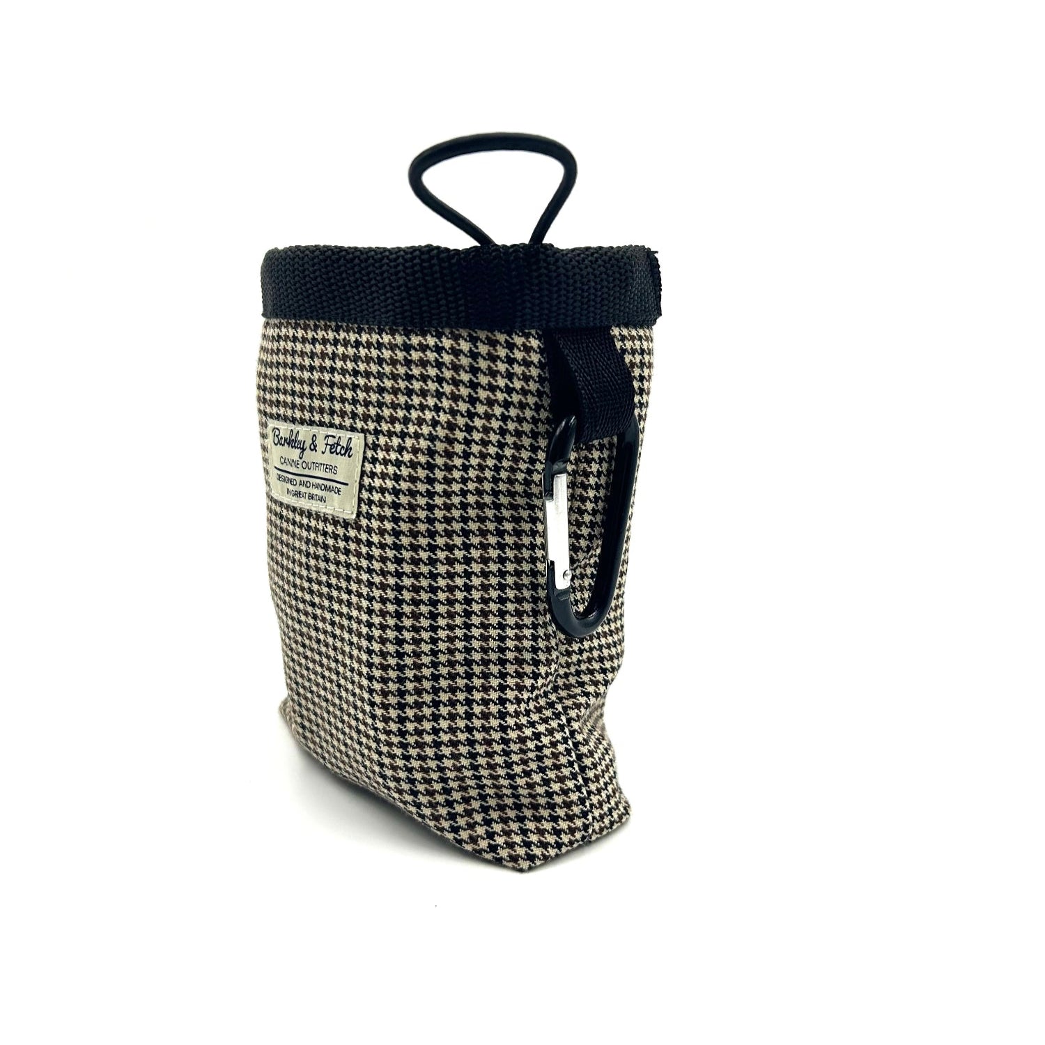 Dog toy with houndstooth pattern and black handle on a white background