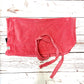 Red dog towel with a knot on a wooden surface handmade in uk by Barkley and Fetch