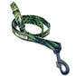 A dog lead with a tropical print in green and blue tones, featuring a metal trigger hook and a D-ring on the handle.