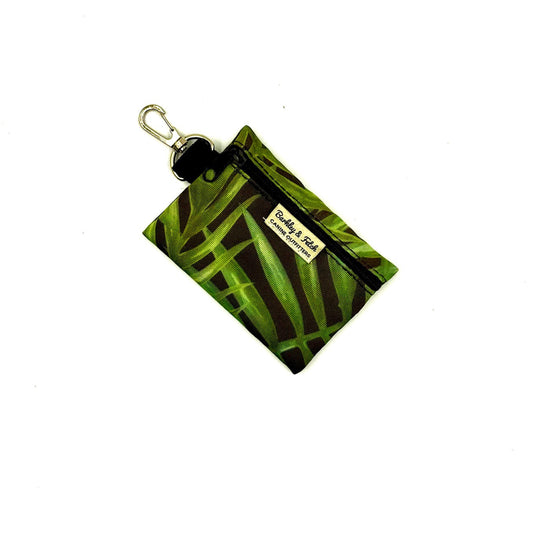 Green patterned pouch with a keychain on a white background