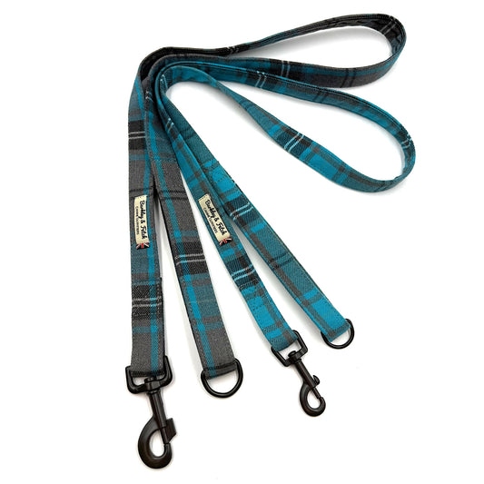 Plaid dog leash with black metal clips on a white background