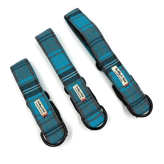 Three blue plaid dog collars with visible brand labels on a white background