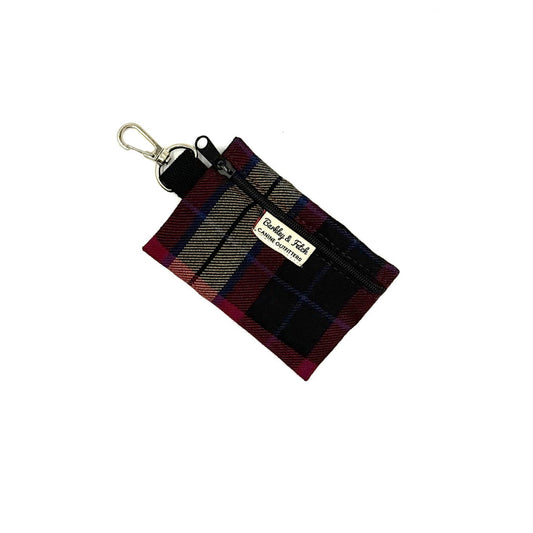 Plaid keychain pouch with a visible brand label on a white background