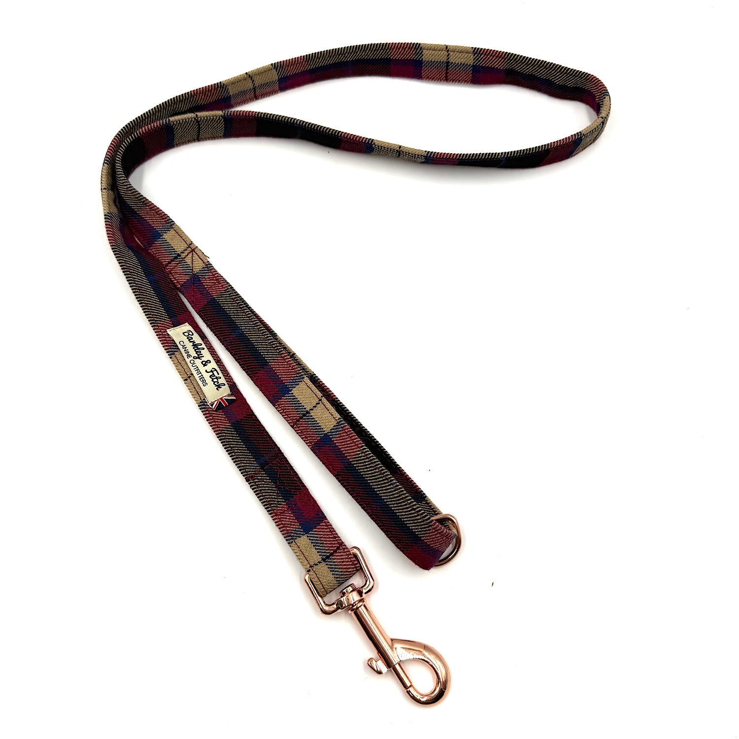 Plaid dog leash with rose gold clip on a white background