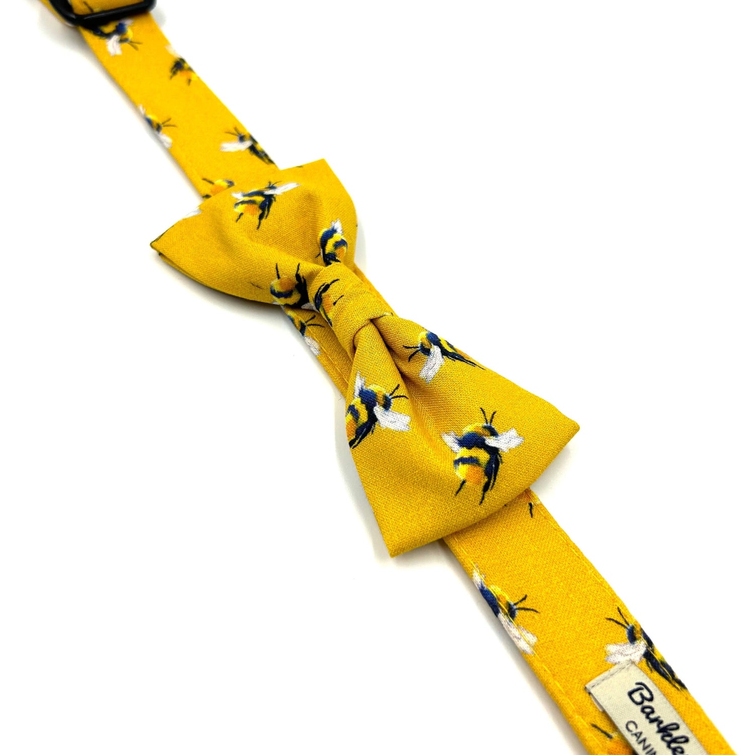 Yellow bow tie with bee pattern on a white background