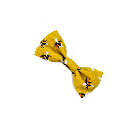Yellow bow tie with black patterns on a white background