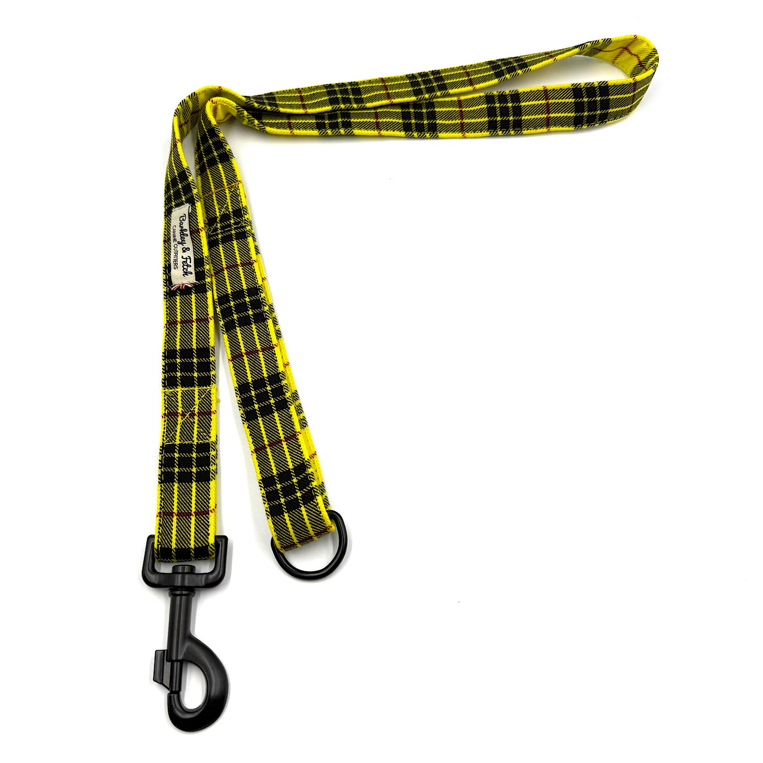 Yellow and black plaid dog leash with a black clip on a white background