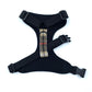 Black dog harness with plaid strap on a white background
