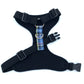 Black dog harness with plaid strap on a white background