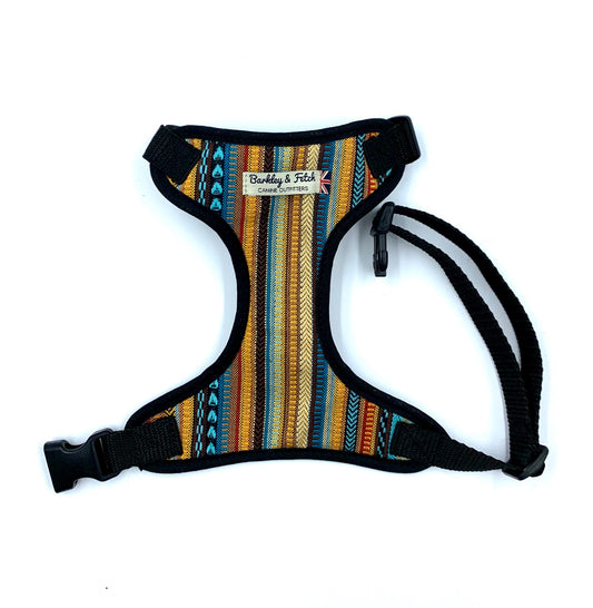 A striped dog harness with black trim and side release buckle, featuring a heavy duty d-ring and brand label.