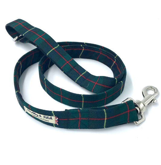 Green and navy tartan dog lead with silver hardware on a white background