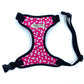 Adjustable hot pink floral print dog harness with black straps and a side release buckle, on a white background.