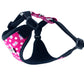Pink floral-patterned dog harness with black straps on a white background