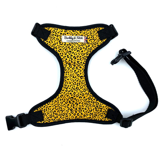 A yellow dog harness with a leopard print pattern, featuring adjustable straps and a side release buckle.