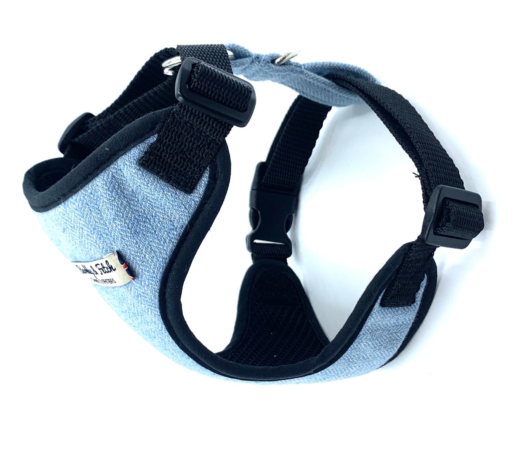 Dog harness with black straps on a white background