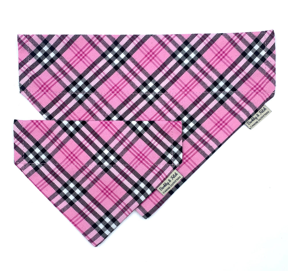 Pink plaid dog bandana with a brand label on a white background