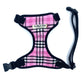 A pink check fabric harness for dogs with a black collar and a heavy duty d-ring, displayed against a white background.