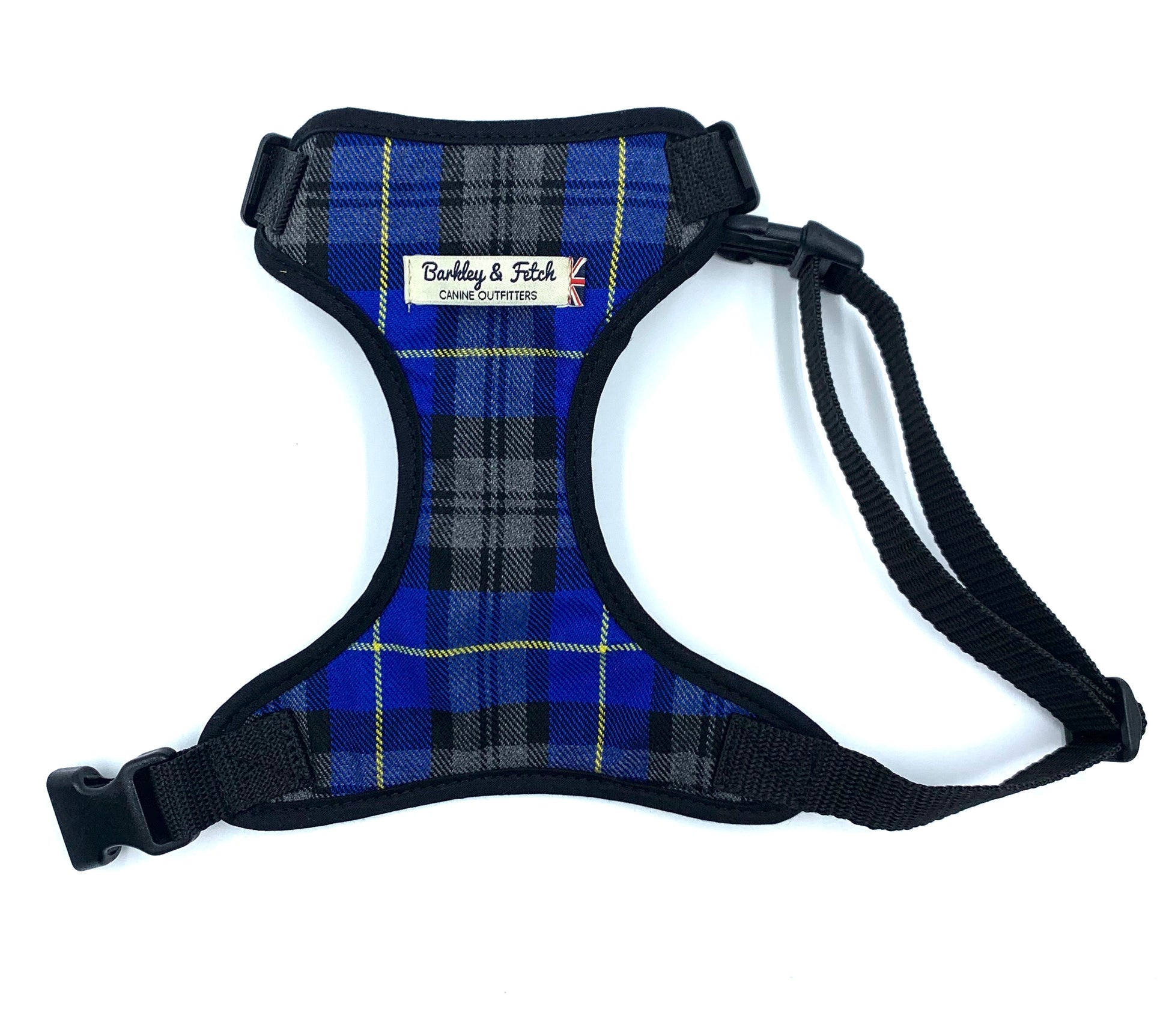 A dog harness with a royal blue tartan pattern, black trim, and adjustable straps, featuring a side release buckle and a heavy duty d-ring.