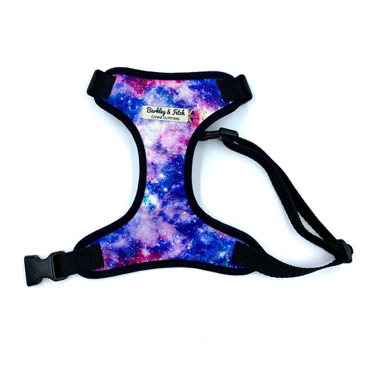 A multicolored fabric dog harness with a space odyssey theme, featuring a black strap and a welded heavy duty d-ring.