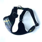 Black dog harness with plaid pattern on a white background