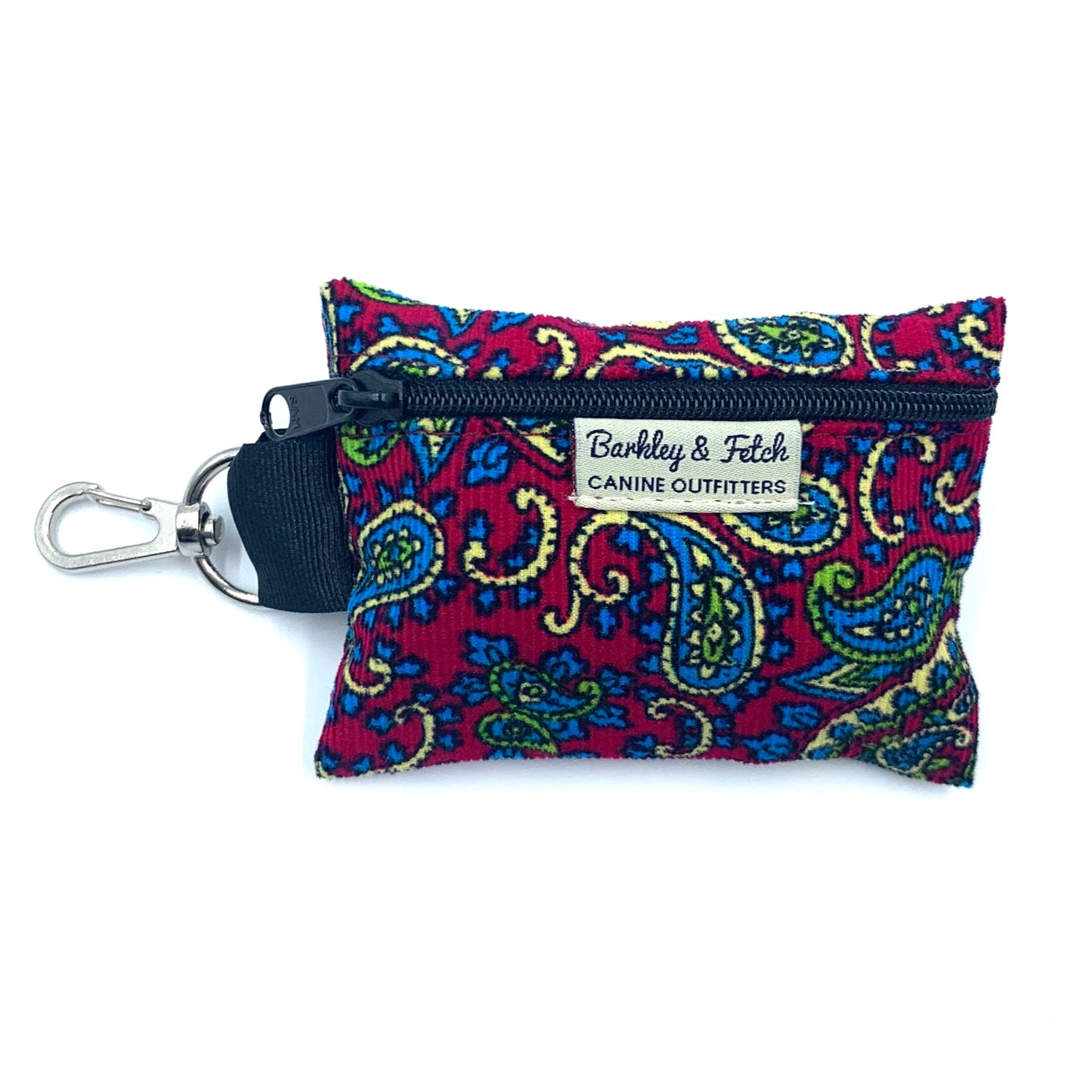 A Cherry Paisley Corduroy poo bag holder with a multicolored pattern, attached to a black clip, against a white background.