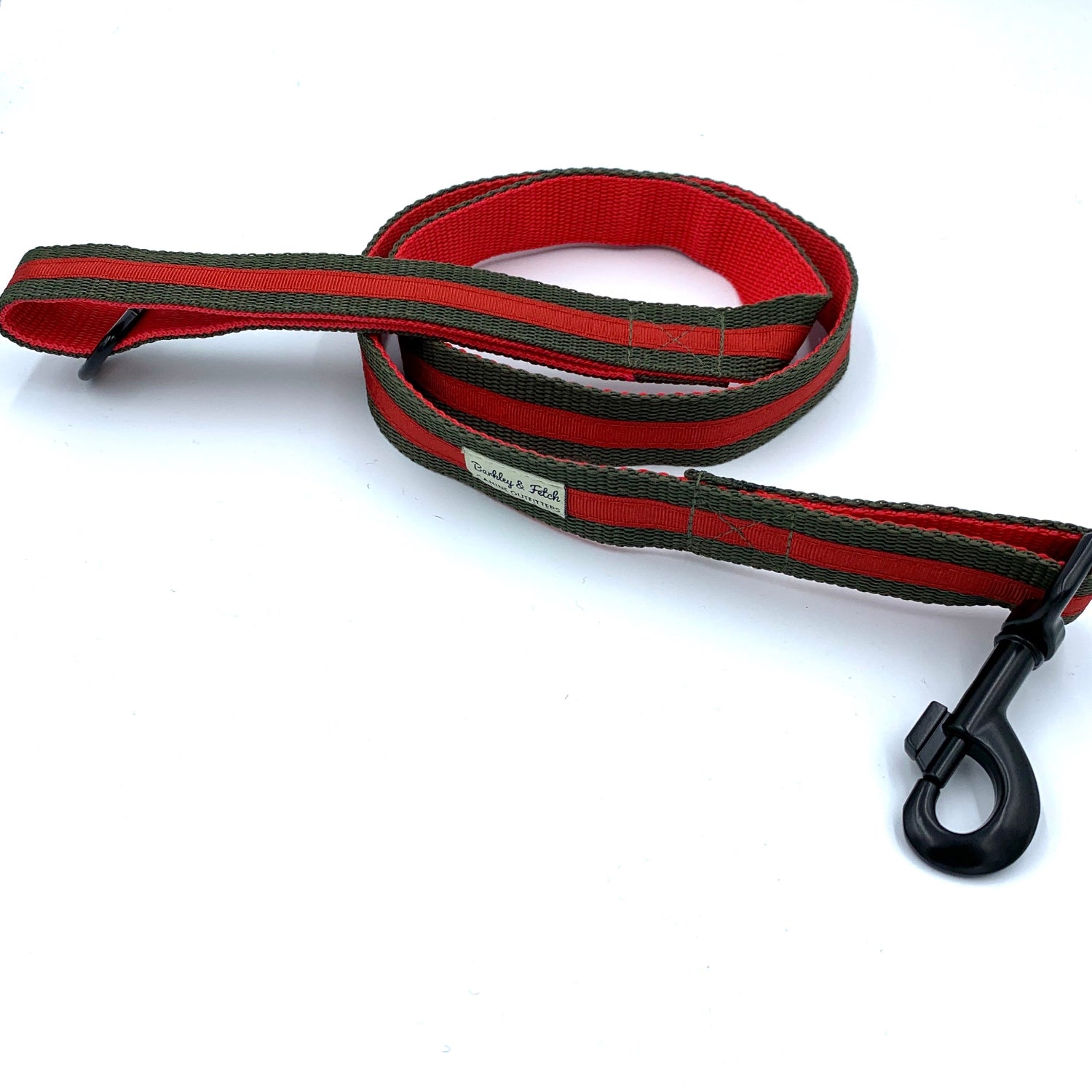 A red and black striped dog lead with a metal trigger hook and a D-ring on the handle.