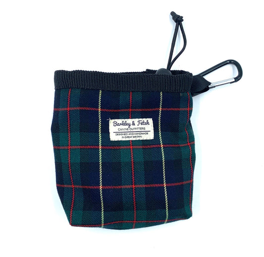 A green and navy tartan treat bag with a label reading 'Barkley & Fetch'. It has a drawcord closure and a clip attachment. Handmade in the Uk by Barkley and Fetch