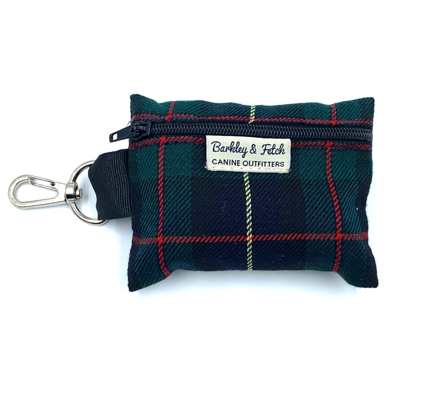 A green and navy tartan print poo bag holder with a metal clip and a brand label reading Barkley and Fetch - CANINE OUTFITTERS'.