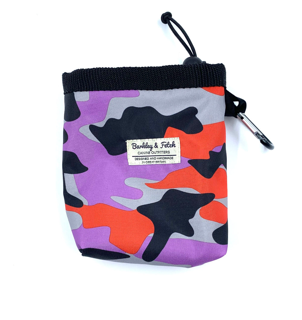 A purple and orange camouflage dog treat bag with an elastic drawcord closure and a brand label on the front.