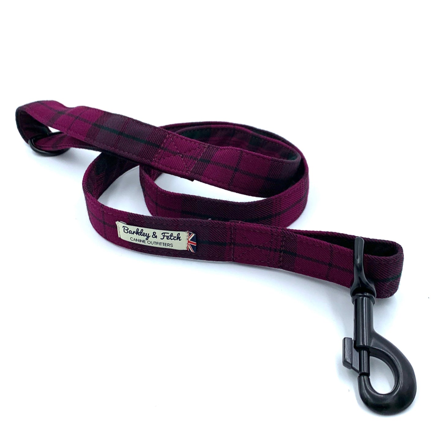 Plaid patterned dog leash with a black clip on a white background