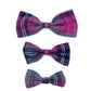 Three plaid bow ties in pink, purple, and gray on a white background