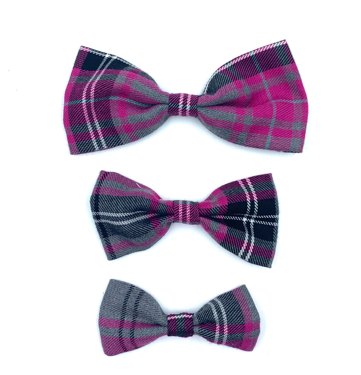 Three plaid bow ties in pink, purple, and gray on a white background