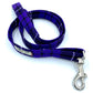 Purple plaid dog leash with a silver clasp on a white background
