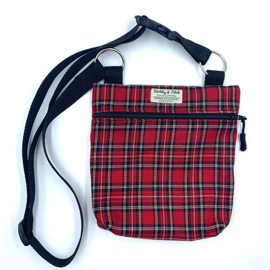A red tartan dog walking and treat bag with an adjustable black shoulder strap, a zip fastening, and a special pocket for poo bags.Handmade in the Uk by Barkley and Fetch