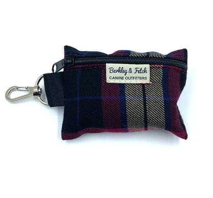 A wine tartan patterned poo bag holder with a metal clip and label, designed to attach to a dog leash.